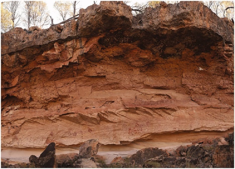 Stratified red rock geological formation marra wonga rockart