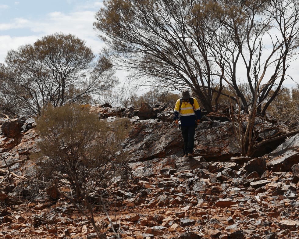 echoes team member hiking on a rocky hill