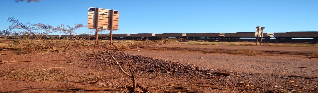 fmg chris creek outback scene with train and sign.
