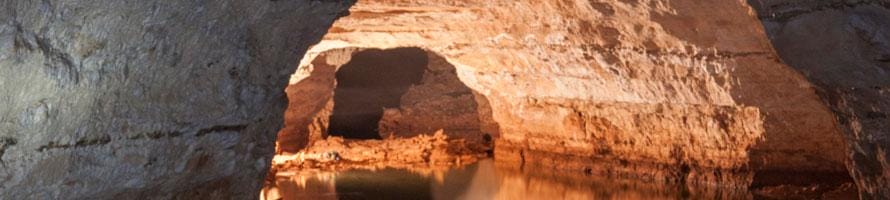 sunlit cave reflected in water